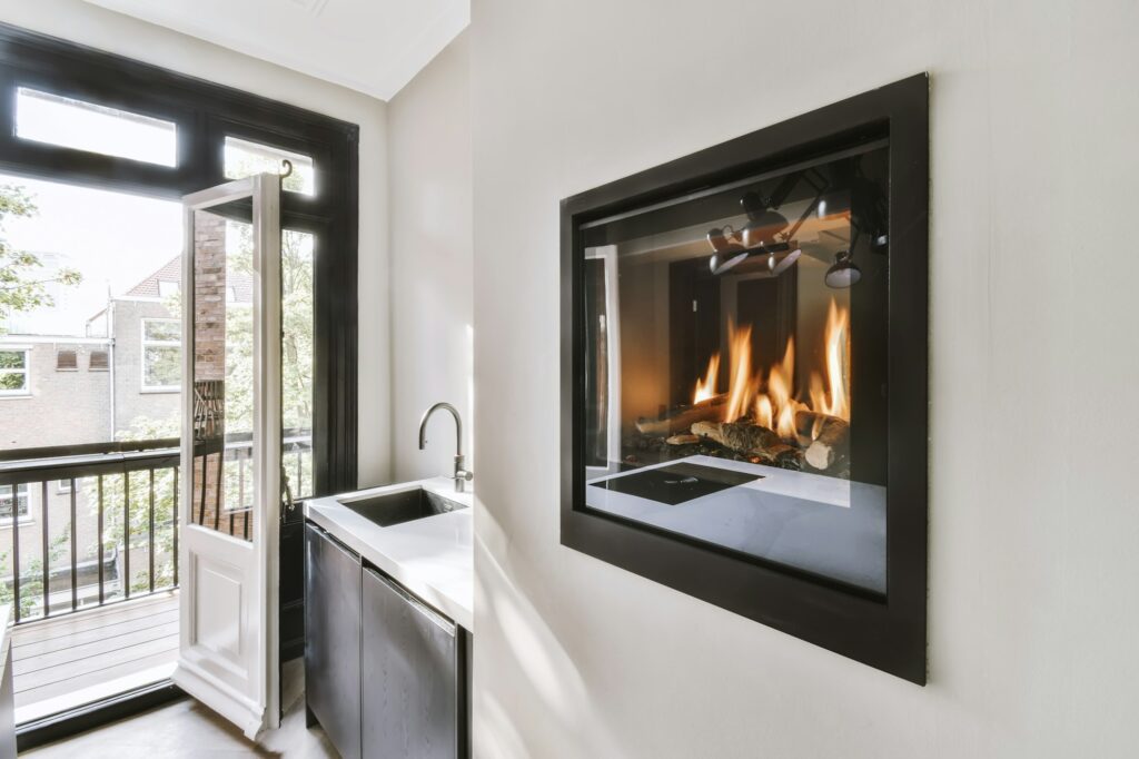 Beautiful burning fireplace next to the kitchen counter